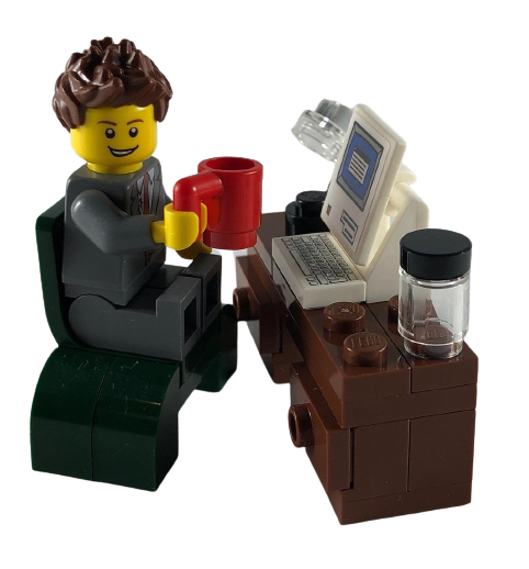 Lego person sat at desk with cup of coffee